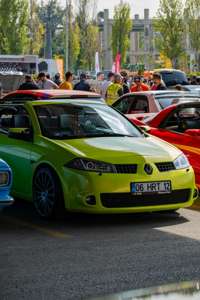 A vibrant display of colorful cars at an outdoor car show in Ankara, Türkiye.